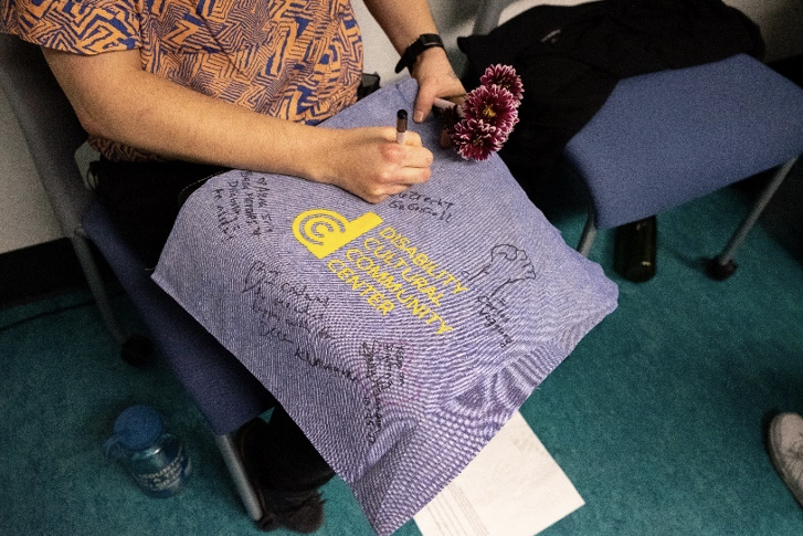 Handwritten messages on a Disability Cultural Community Center cloth
